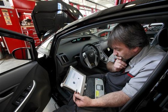 Master Diagnostic Technician Kurt Juergens, of Foxborough, Mass., uses a laptop computer to diagnose and repair the brake system on a 2010 Toyota Prius in the repair shop of a Toyota dealership, in Norwood, Mass.
